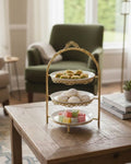 Luxury 3-tier gold dessert stand with Arabic sweets on wooden table
